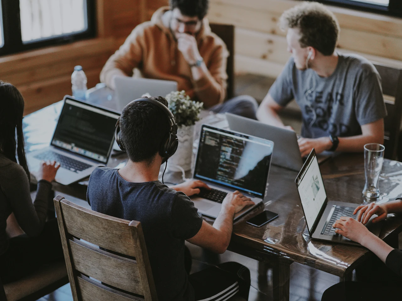 A software team collaborating around a shared workstation